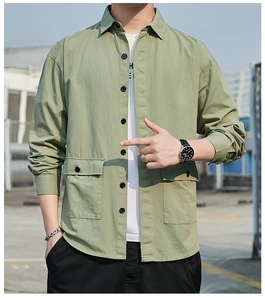 Detailed view of casual grass green workwear shirt with large utility pockets and button closure