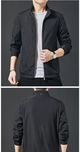Détail d'une veste noire pour homme montrant le zip argenté et le ruban tricolore au col