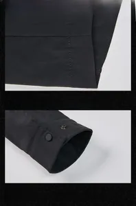 Detail view of black casual jacket with matte snaps, dual-stitching, and cuff button accents