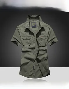 Close-up of military green short sleeve shirt featuring dual flap pockets and cotton fabric