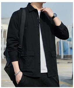 Detail view of men's casual black utility shirt featuring classic collar and flap pockets