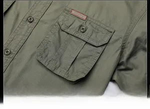 Detailed macro view of military green cotton shirt featuring cargo pocket and leather label