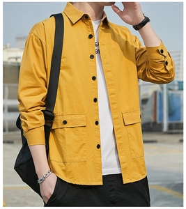 Detail view of ginger yellow workwear shirt featuring dual flap pockets and black buttons