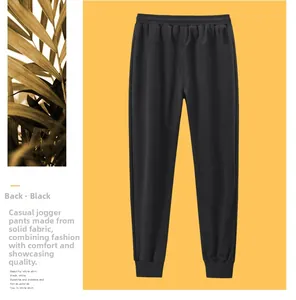 Vue arrière du pantalon jogging noir en coton pour homme avec taille élastique sur fond jaune