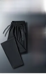 Detail of men's ice silk pants featuring an elastic waist and a functional side zipper pocket