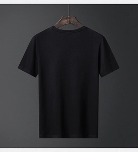 Detail view of the smooth fabric and crew neck on a black cotton short sleeve T-shirt