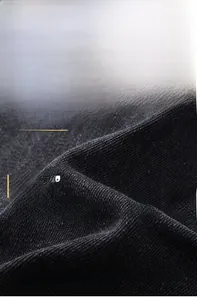 Close-up of black breathable denim fabric showing durable twill texture and wrinkle resistance