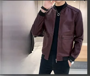 Detail of slim-fit burgundy PU leather jacket showing ribbed cuffs and flap pockets