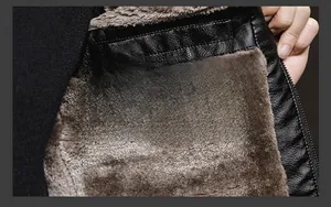 Close-up of winter faux leather jacket with thick brown fleece lining and lychee texture