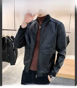 Detail of a black faux leather bomber jacket featuring a stand collar and large pockets