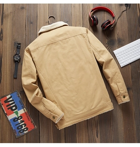 Detail of winter canvas jacket featuring warm white fleece collar and durable fabric