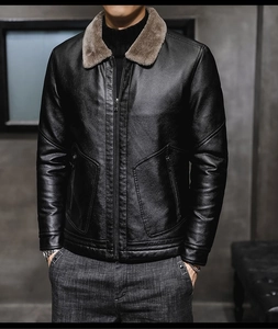 Detail of men's leather jacket featuring soft faux fur collar and metal zipper pocket
