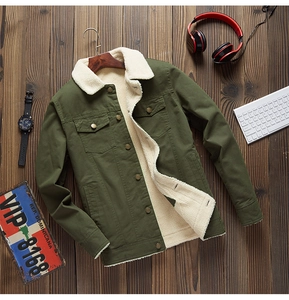 Detailed close-up of army green utility jacket with warm faux shearling lining