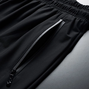 Men's ice silk sport pants featuring elastic waistband and secure zipper pockets