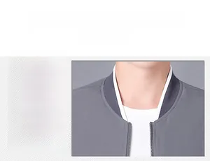 Close-up of grey bomber jacket showing the ribbed collar detail and smooth fabric texture