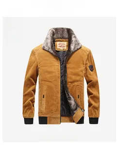 Detail view of yellow corduroy winter jacket with thick grey fur collar and quilted lining