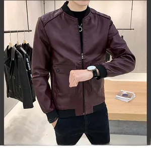 Detail of burgundy PU leather jacket featuring ribbed cuffs and large snap pockets