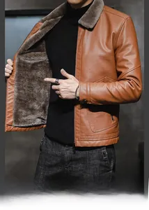 Detail view of winter leather jacket showing plush fur lining and texture on wide collar