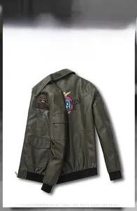 Detail view of army green faux leather bomber jacket with tactical eagle badges and print