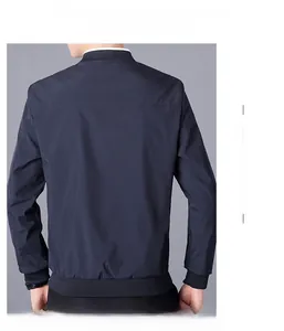 Detail view of navy blue bomber jacket back showing ribbed cuffs and minimal stitching