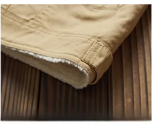 Close-up of khaki winter work jacket hem with thick warm white fleece lining