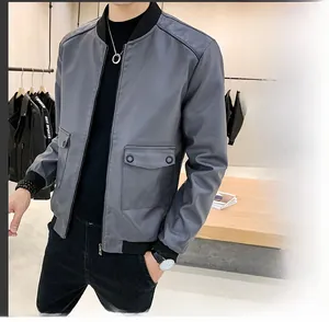 Detail view of grey faux leather bomber jacket with ribbed collar and flap pockets