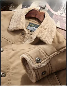 Detail view of the warm lamb velvet collar and metallic button of this men's khaki cotton jacket