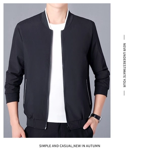 Detail of black bomber jacket showing ribbed cuffs and side pockets with white trim