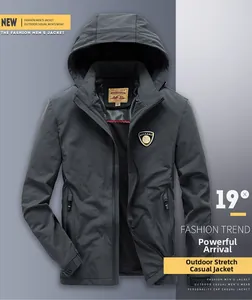 Close-up of dark grey men's hooded windbreaker featuring a chest badge and elastic fabric