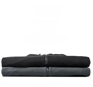 Detailed view of stacked black and charcoal casual pants with precise stitching and zipper