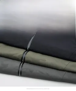 Macro detail of men's casual outdoor jackets in black and camouflage with zip closure