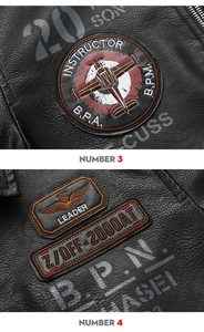 Detail of vintage eagle embroidery and instructor patches on black leather biker jacket