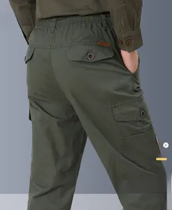 Detail view of olive green cargo pants featuring elastic waist and multiple flap pockets