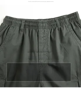 Detail of deep grey cargo pants showing elastic waistband and fine twill fabric texture