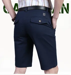 Detail view of men's navy cotton shorts featuring a rear pocket flap and fashion leather patch