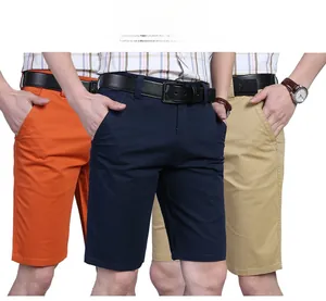 Close-up of cotton cargo shorts in orange, navy, and khaki showing pockets and belt details