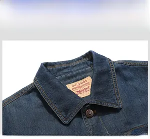 Detail view of denim jacket collar with contrast stitching and leather brand label