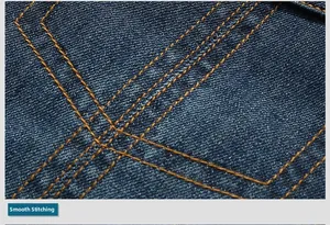 Detailed macro view of smooth orange double stitching on dark blue denim jacket