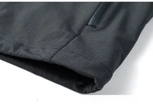Macro detail of men jacket hem showing waterproof zipper pocket and double stitched edge