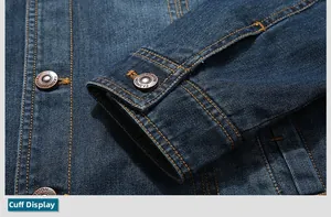 Detail of dark blue denim jacket cuff and bronze metal buttons with fashion engraving