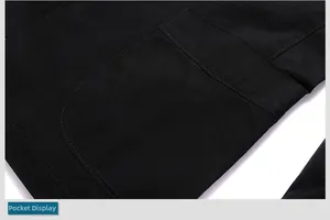 Detail of the large patch pocket on a black cotton jacket with reinforced double stitching
