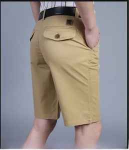 Detail view of khaki cotton cargo shorts featuring a buttoned back pocket and twill texture