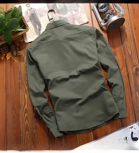 Detailed back view of an army green cotton cargo shirt with horizontal seam on wood background