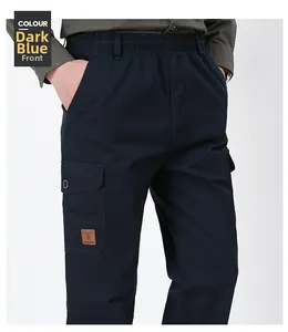 Detail of men's black blue cargo pants featuring elastic waist and Freedom leather patch