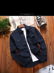 Detail of navy blue cotton shirt showing front flap pockets and casual layered style