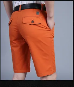 Close-up of orange men's casual shorts showing back pocket detail and tailored fit