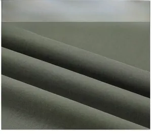 Macro detail of olive green cotton twill fabric showing soft texture and weave