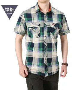 Detail of green plaid cotton shirt featuring symmetric double chest pockets and fashion tag