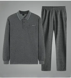 Detailed view of dark gray men's polo tracksuit featuring ribbed cuffs and chest pocket