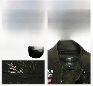 Detail of military green cotton jacket showing shark teeth embroidery and inner collar label